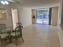 Bright living room with tile flooring, large sliding glass doors opening to screened in patio at 519 Albee Farm Rd # 116, Venice, FL 34285