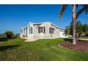 Bright single Gathering home with a manicured lawn and mature landscaping at 6037 Shearwater Dr, Englewood, FL 34224