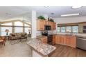 Open concept kitchen with modern appliances, granite countertops, and ample cabinet space at 6037 Shearwater Dr, Englewood, FL 34224
