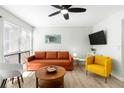 Bright living room featuring a ceiling fan and comfortable furniture at 6157 Midnight Pass Rd # D31, Sarasota, FL 34242