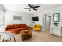 Cozy living area with a barn door, ceiling fan and stylish decor at 6157 Midnight Pass Rd # D31, Sarasota, FL 34242