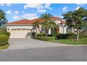 Charming single-story home features a tile roof, mature landscaping, and a two-car garage at 6210 Cormorant Ct, Bradenton, FL 34203