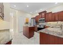 Well-equipped kitchen boasts stainless steel appliances, granite countertops, and ample cabinet space at 6210 Cormorant Ct, Bradenton, FL 34203