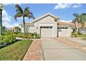 Charming single-story home with a 2-car garage, tile roof, and well-manicured landscaping at 651 Back Nine Dr, Venice, FL 34285