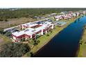 Aerial view of condo complex near the water and surrounded by trees at 66 Boundary Blvd # 275, Rotonda West, FL 33947