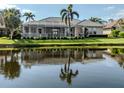 Waterfront property with screened-in porch and peaceful water views at 692 Egret Walk Ln, Venice, FL 34292