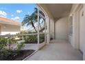 A screened in porch showing the manicured landscape and tiled concrete floor at 7104 L Pavia Blvd # 7104, Venice, FL 34292