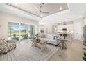Open-concept living room with a view of the kitchen, pool, and sliding glass doors at 7407 S Blue Sage, Punta Gorda, FL 33955
