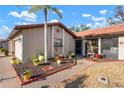 Well-maintained single Gathering home entrance featuring rock landscaping, pathway, and potted plants at 867 Country Club Cir #71, Venice, FL 34293