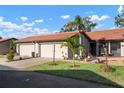 Charming single Gathering home with a two-car garage, concrete driveway and well-manicured front yard at 867 Country Club Cir #71, Venice, FL 34293