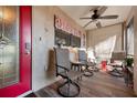 Cozy screened-in lanai with tile flooring, ceiling fan, outdoor seating, and bright red door at 867 Country Club Cir #71, Venice, FL 34293