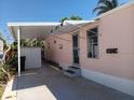 Exterior angle of the house, carport, steps, and a green door at 871 S Green Cir, Venice, FL 34285