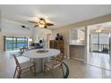 Open-concept dining room with views of the living room, kitchen, and waterfront at 990 Bird Bay Way # 258, Venice, FL 34285