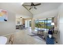 Bright living room features high ceilings, tile floors and a large balcony with water views at 990 Bird Bay Way # 258, Venice, FL 34285