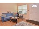 Cozy living room with a comfortable blue sofa and stylish décor creating a welcoming atmosphere at 1000 Gardens Edge Dr # 1023, Venice, FL 34285