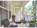 Comfortable screened porch with a chair and various plants creating a cozy outdoor space at 1000 Gardens Edge Dr # 1023, Venice, FL 34285