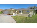 Beautiful home with a charming facade, lush green lawn, and a well-maintained exterior with lovely curb appeal at 1003 N Gondola Dr, Venice, FL 34293