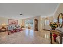 Bright living room with tile floors, a large window, and comfortable seating, perfect for relaxation and entertaining guests at 1003 N Gondola Dr, Venice, FL 34293