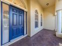 Elegant front door with sidelights, arched windows, and a brick-paved porch at 101 Portofino Dr, North Venice, FL 34275