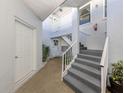 A welcoming entrance with staircase and white door provides access to the residence at 1041 Capri Isles Blvd # 224, Venice, FL 34292