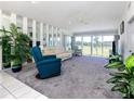 Spacious living room featuring large windows and comfortable furnishings at 1041 Capri Isles Blvd # 224, Venice, FL 34292
