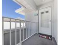 A welcoming front porch boasts a beach-themed entrance with a charming doormat at 1041 Capri Isles Blvd # 224, Venice, FL 34292