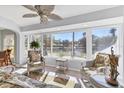 Bright sunroom with views of a tranquil lake, with stylish, comfortable seating at 109 Southampton N Pl # 245, Venice, FL 34293