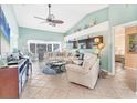 Comfortable living room with tile floors, vaulted ceiling, and open access to sunroom at 109 Southampton N Pl # 245, Venice, FL 34293