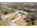 Expansive property featuring a single-story home, long driveway, and mature trees at 1110 Gladstone Blvd, Englewood, FL 34223