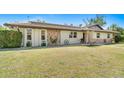 Charming single-story home featuring a well-manicured lawn, stone accents, and mature landscaping at 1110 Gladstone Blvd, Englewood, FL 34223
