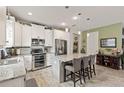 Bright kitchen featuring stainless steel appliances, granite countertops, and a large island with seating at 11655 Renaissance Blvd, Venice, FL 34293