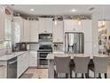 Bright kitchen featuring stainless steel appliances, granite countertops, and a large island with seating at 11655 Renaissance Blvd, Venice, FL 34293