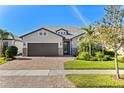 Beautiful single-story home featuring a two-car garage, manicured lawn, and charming curb appeal at 13251 Borrego St, Venice, FL 34293
