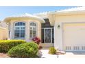 Attractive one-story home with a well-maintained lawn and a charming decorative front door at 14 Windward Ter, Placida, FL 33946