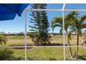 Enjoy the outdoor views from the comfort of a screened lanai overlooking a well-manicured lawn at 14 Windward Ter, Placida, FL 33946