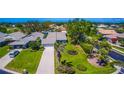 Aerial view of a home nestled amongst manicured lawns, mature trees and shrubbery in this golf course community at 1400 Colony Pl, Venice, FL 34292