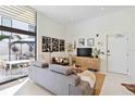 Bright living room with a large window showcasing the outdoor patio area at 1558 4Th St # 208, Sarasota, FL 34236