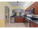 Stylish kitchen featuring stainless steel appliances and a breakfast bar looking into the dining area at 1567 Monarch Dr, Venice, FL 34293
