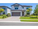Beautiful two-story home with a well-maintained lawn and paved driveway at 16258 Hidden Oak Loop, Bradenton, FL 34211