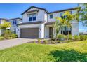 Two-story home with well-maintained lawn and garden, featuring a two-car garage at 16258 Hidden Oak Loop, Bradenton, FL 34211