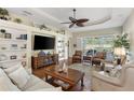 Comfortable living room with built-in shelving, entertainment center and sliding glass doors to patio at 1627 Lancashire Dr, Venice, FL 34293