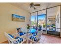 Charming sunroom features a glass table and colorful seating, with views of the outdoor scenery at 200 Park N Blvd # 108, Venice, FL 34285