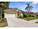 Inviting single-Gathering home with a barrel tile roof, two-car garage, and well-maintained landscaping at 2292 Harrier Way, Nokomis, FL 34275