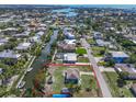 Aerial view of waterfront home with lush landscaping and canal access outlined in red at 328 Channel Ln, Nokomis, FL 34275