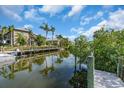 Waterfront property with private dock and lush tropical landscaping at 328 Channel Ln, Nokomis, FL 34275