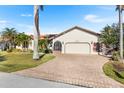Charming single-story home featuring a brick driveway, well-maintained lawn, and an attached two-car garage at 3819 Aves Island Ct, Punta Gorda, FL 33950