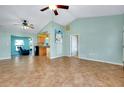 Bright and airy living room with vaulted ceilings and tile floors offering ample space for relaxation at 420 Zephyr Rd, Venice, FL 34293
