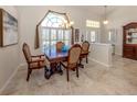 Elegant dining room with a chandelier, large window, and a classic wooden table at 4358 Via Del Villetti Dr, Venice, FL 34293