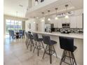 Modern kitchen with sleek countertops, barstool seating, and stainless steel appliances at 4358 Via Del Villetti Dr, Venice, FL 34293