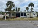 This cozy one-story home features a screened in porch and is beautifully landscaped with palm trees at 530 Via Veneto, Venice, FL 34285